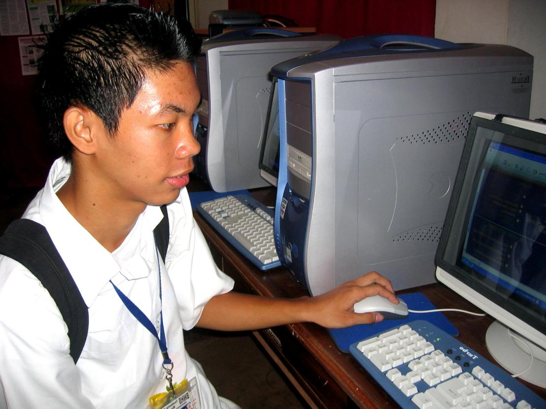 Young boy high school student from philippines using computers